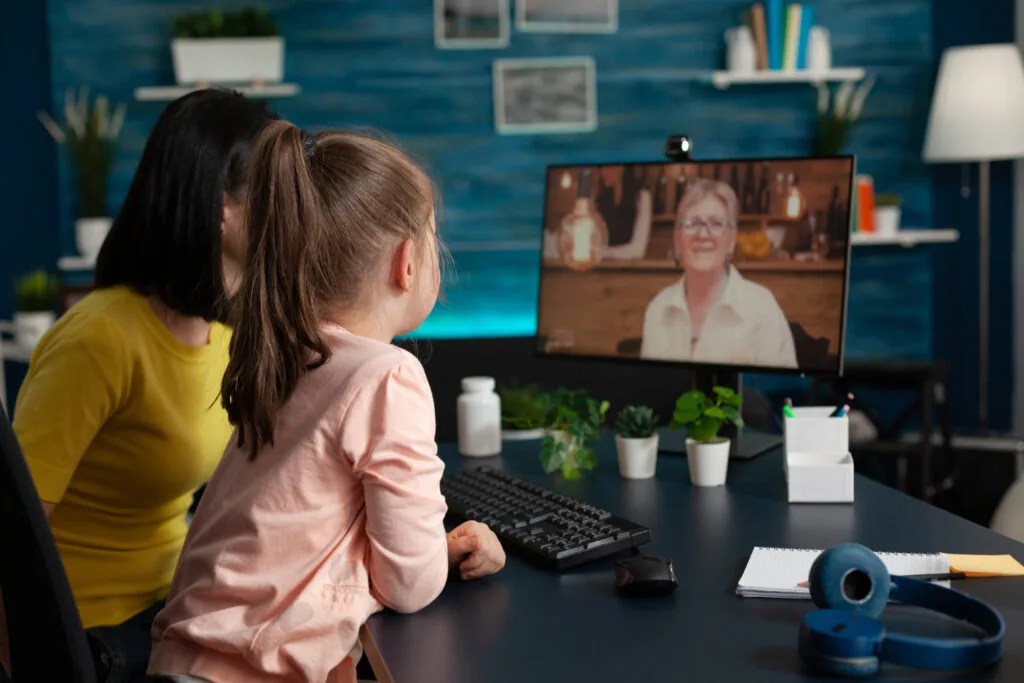 Therapist conducting virtual ABA session on laptop with parent involvement